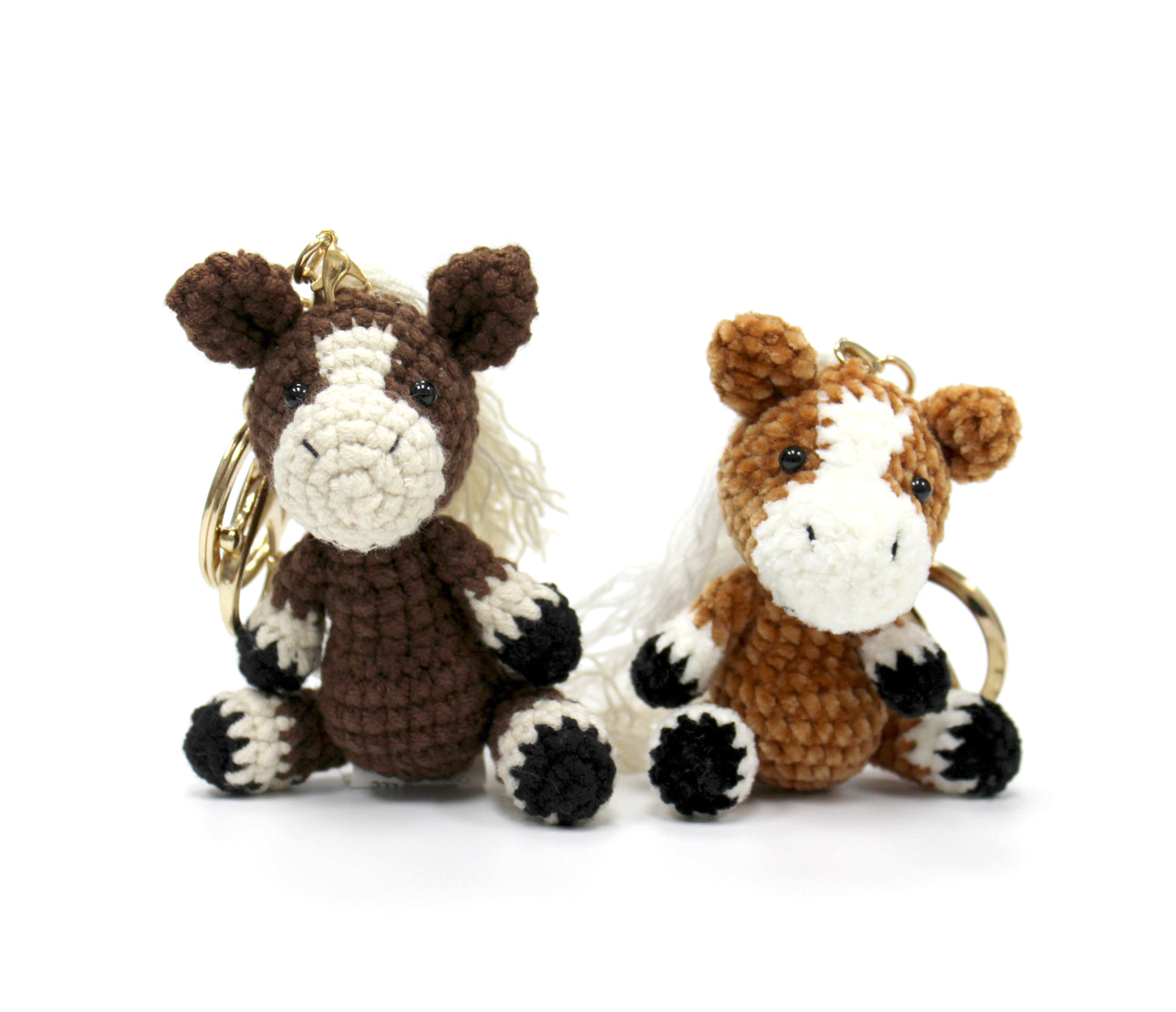 Handmade crochet horse keychains, 3 inches tall, featuring brown and cream color options with white manes and black hooves.