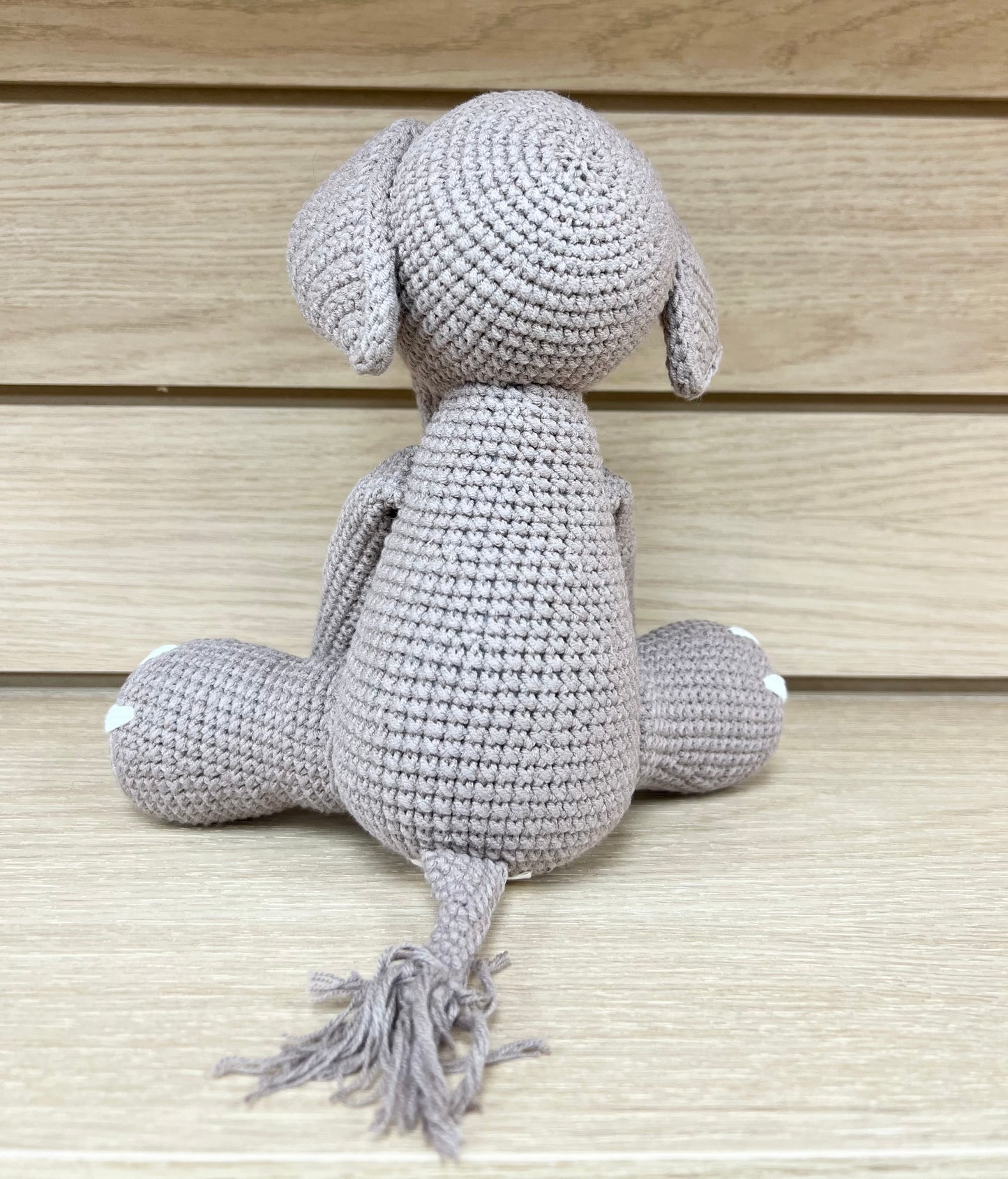 "Handmade crochet elephant toy in light gray, featuring detailed crochet eyes and a soft texture."