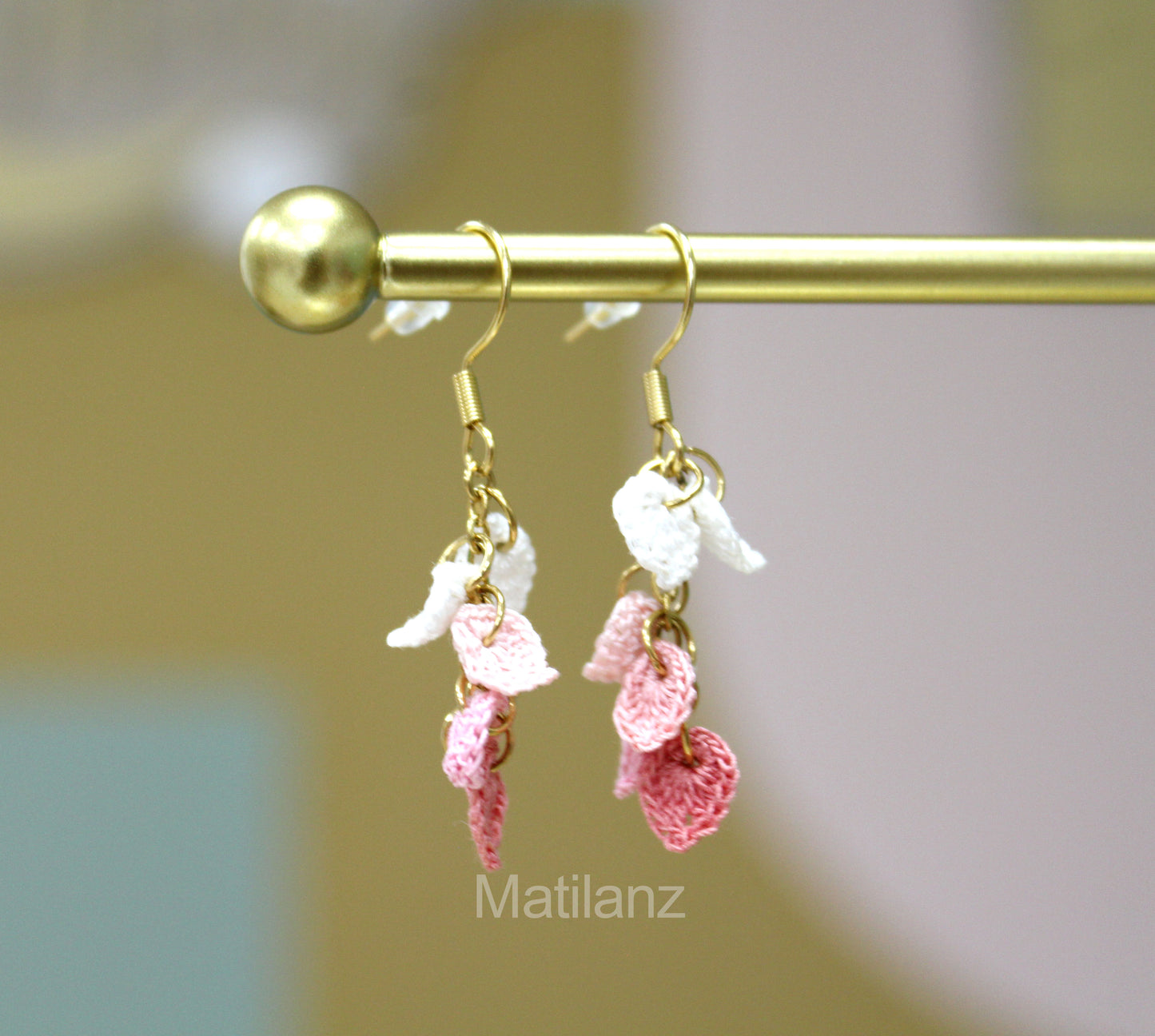 Crochet handmade earrings with pink and white angel wings, delicate and charming.