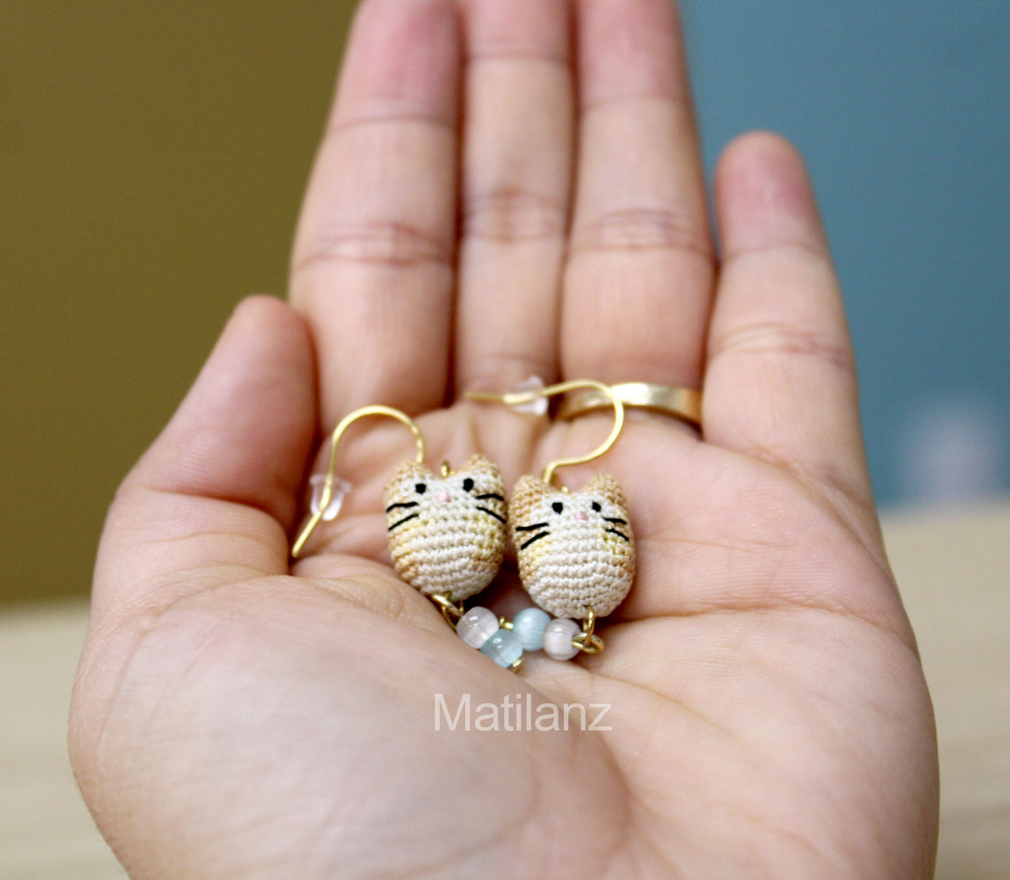 Crochet handmade earrings featuring mini cat faces with beads, perfect for collectors.