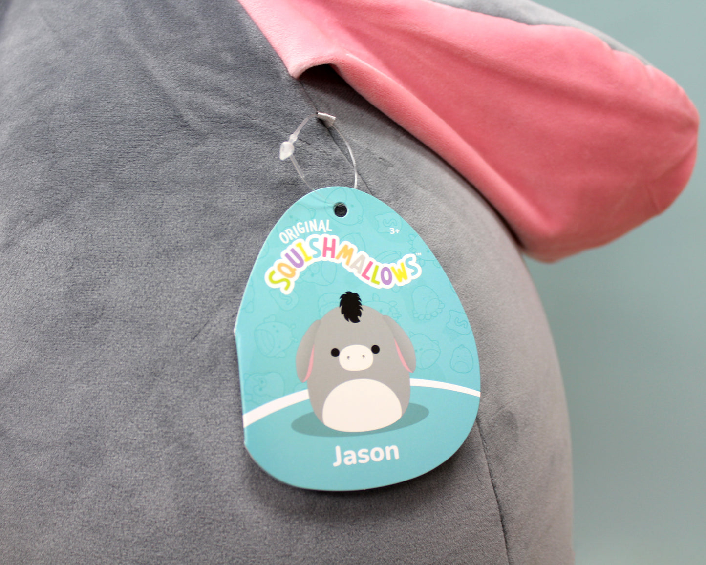 Gray plush donkey with pink ears, soft and cuddly, perfect for hugging.