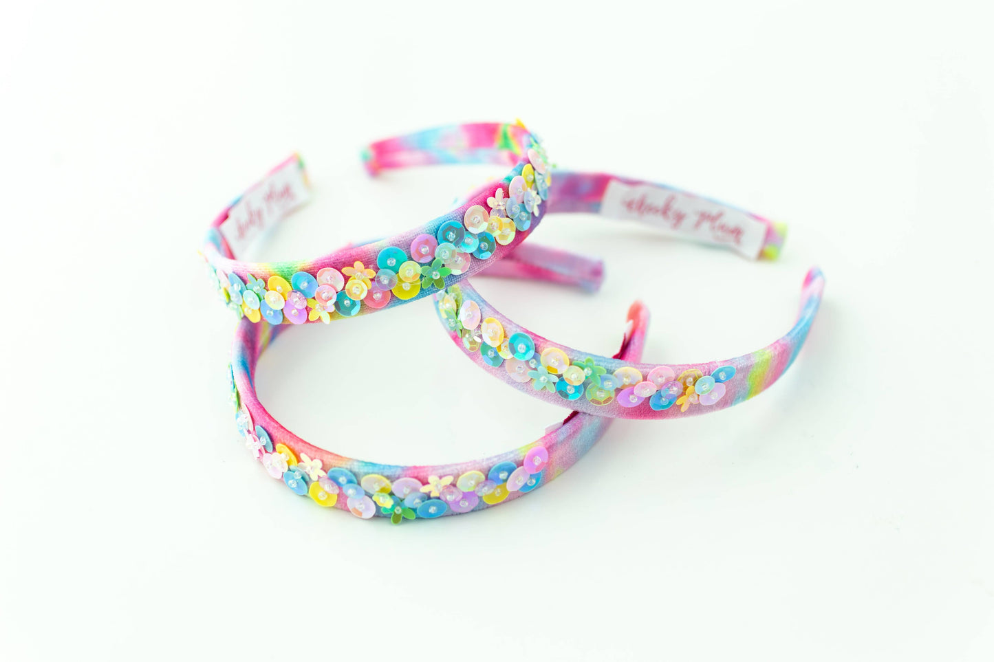 Colorful pastel tie-dye headband adorned with iridescent floral sequins and small beads.