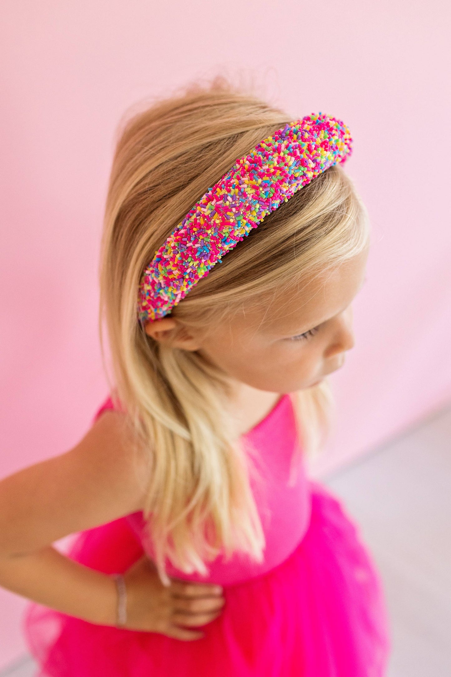 Pink beaded headband adorned with colorful sprinkles, perfect for fun and unique accessories.