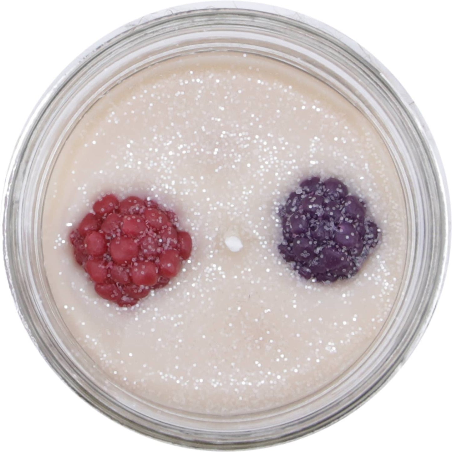 Clear glass jar candle with creamy wax, glitter, and red and purple berry decorations, featuring plum, rose, and vanilla scents.