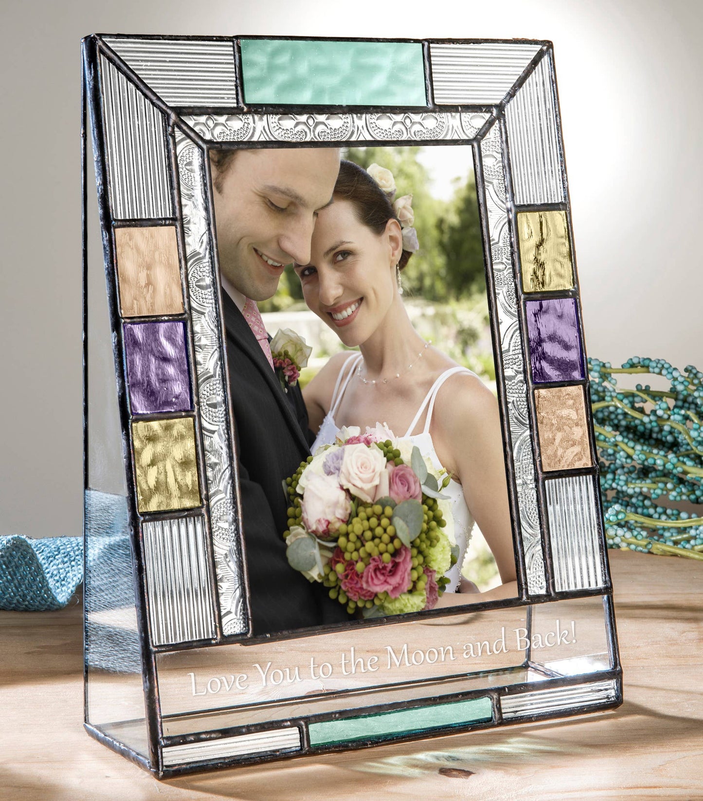 A stained-glass photo frame with colorful panels and an engraved message, perfect for unique gifts.