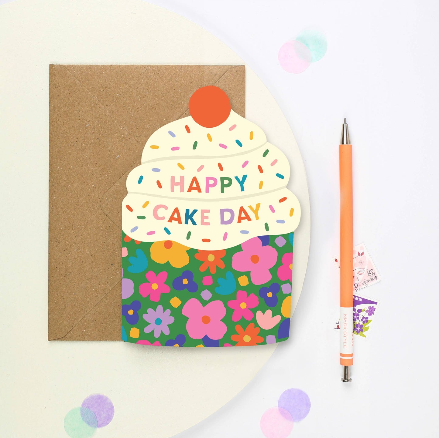 Cupcake-shaped birthday card with rainbow text and floral base
