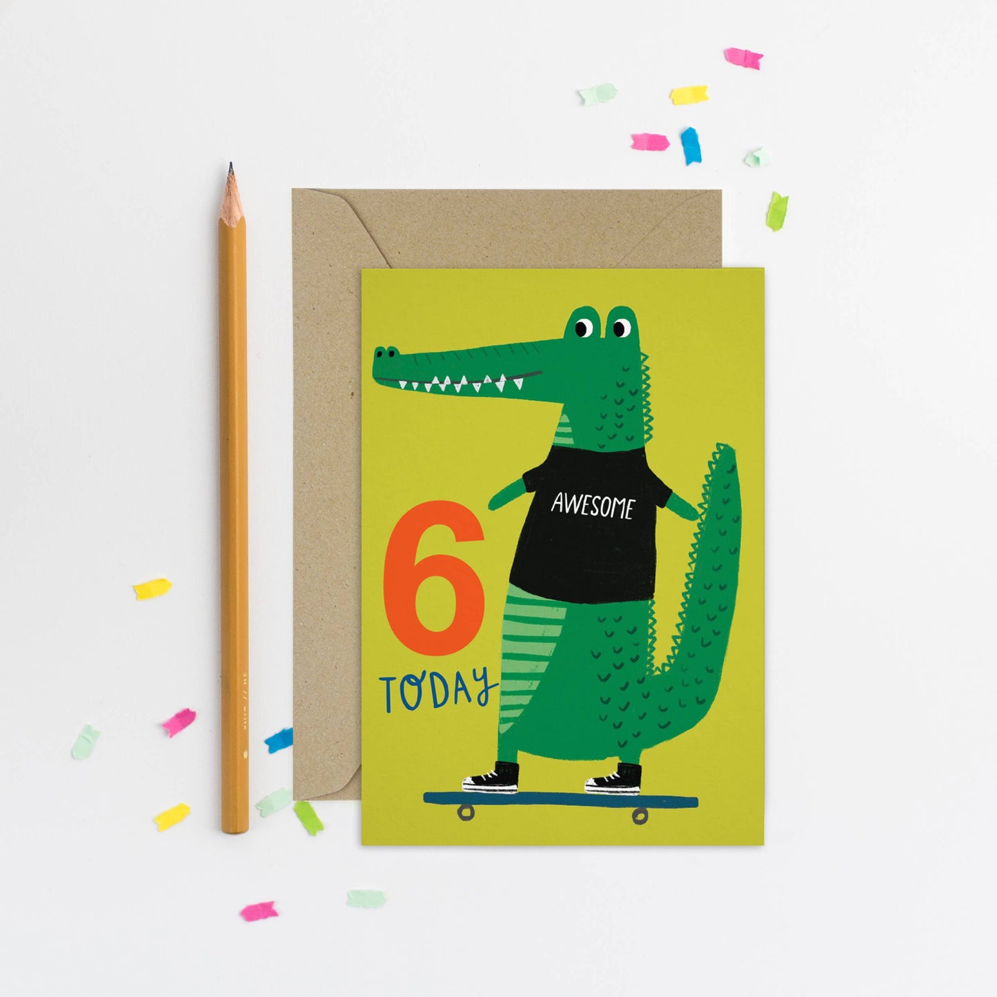 Illustrated birthday card with green crocodile wearing 'Awesome' shirt and standing on a skateboard
