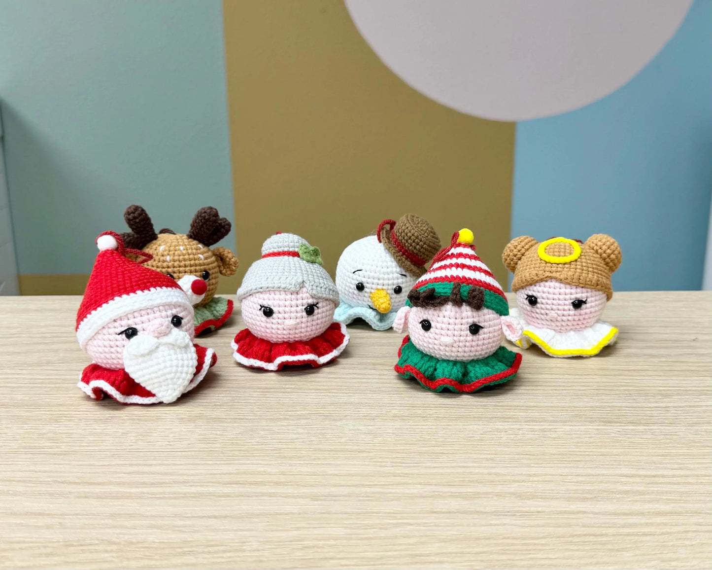 Cute crochet Christmas elf ornament with green and red outfit, festive hat, and cheerful expression.