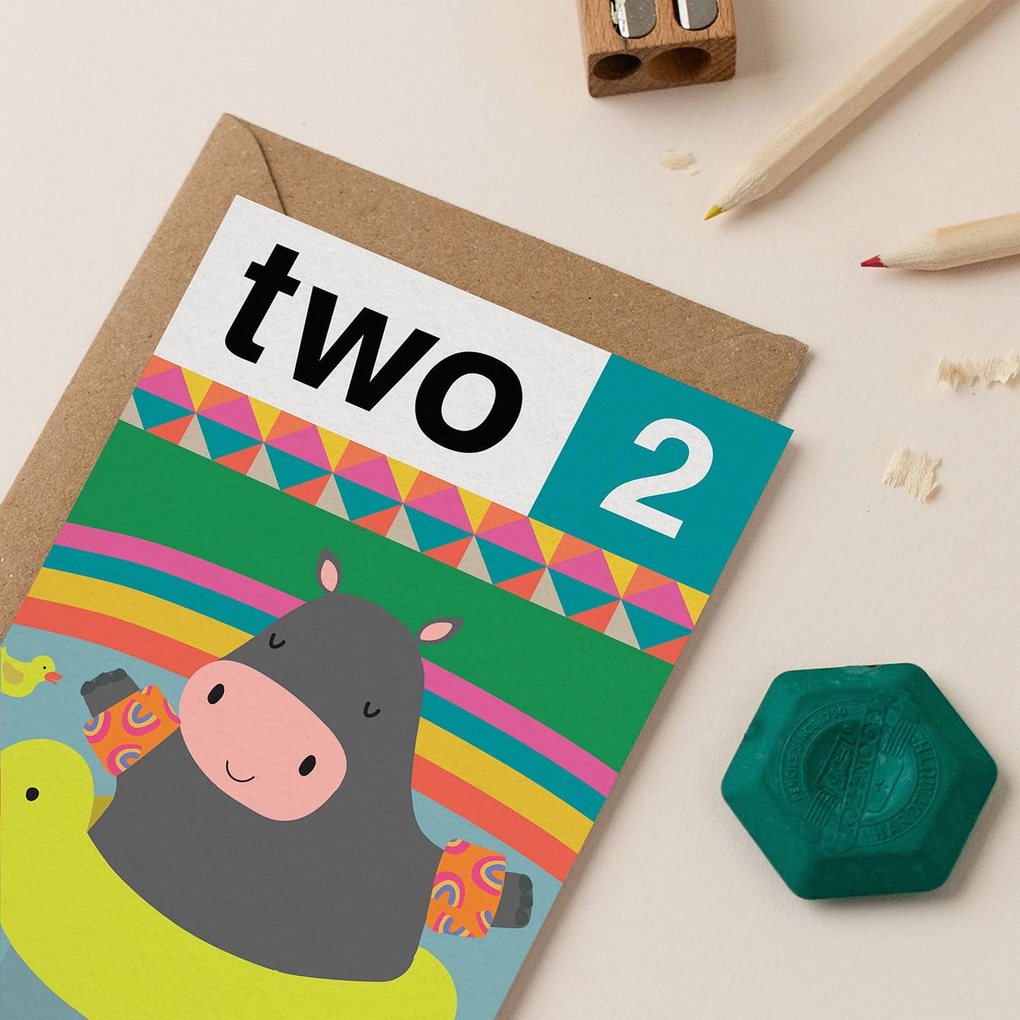 A colorful, gender-neutral 2nd birthday card featuring a hippo illustration and geometric patterns.