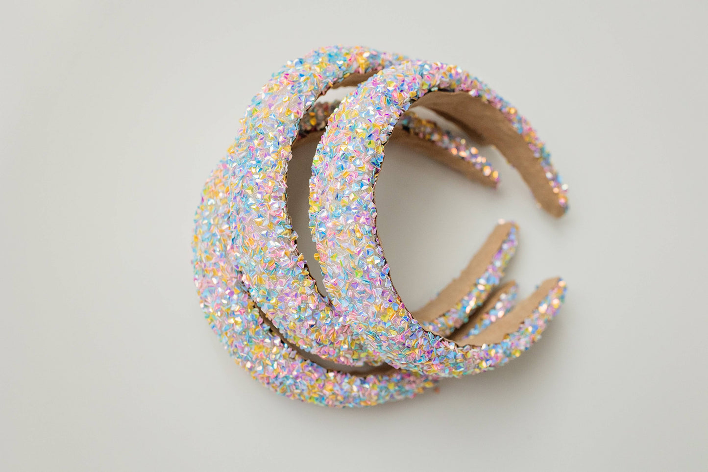 Pastel headband adorned with iridescent crystals, perfect for a festive party look.