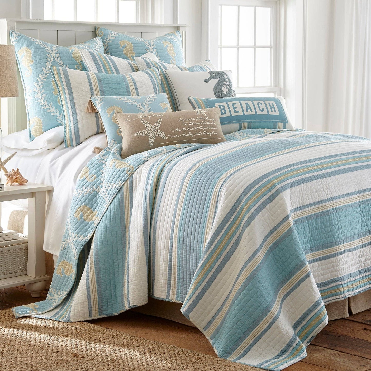 A blue and white striped decorative beach pillow with a starfish design.