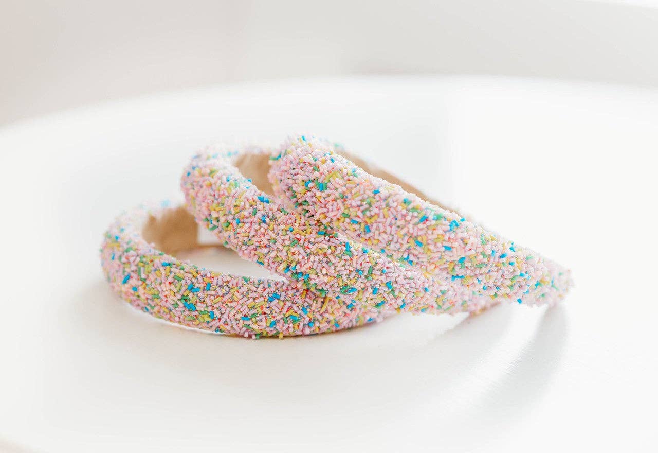 Pink beaded headband with colorful sprinkle design, perfect for playful outfits.