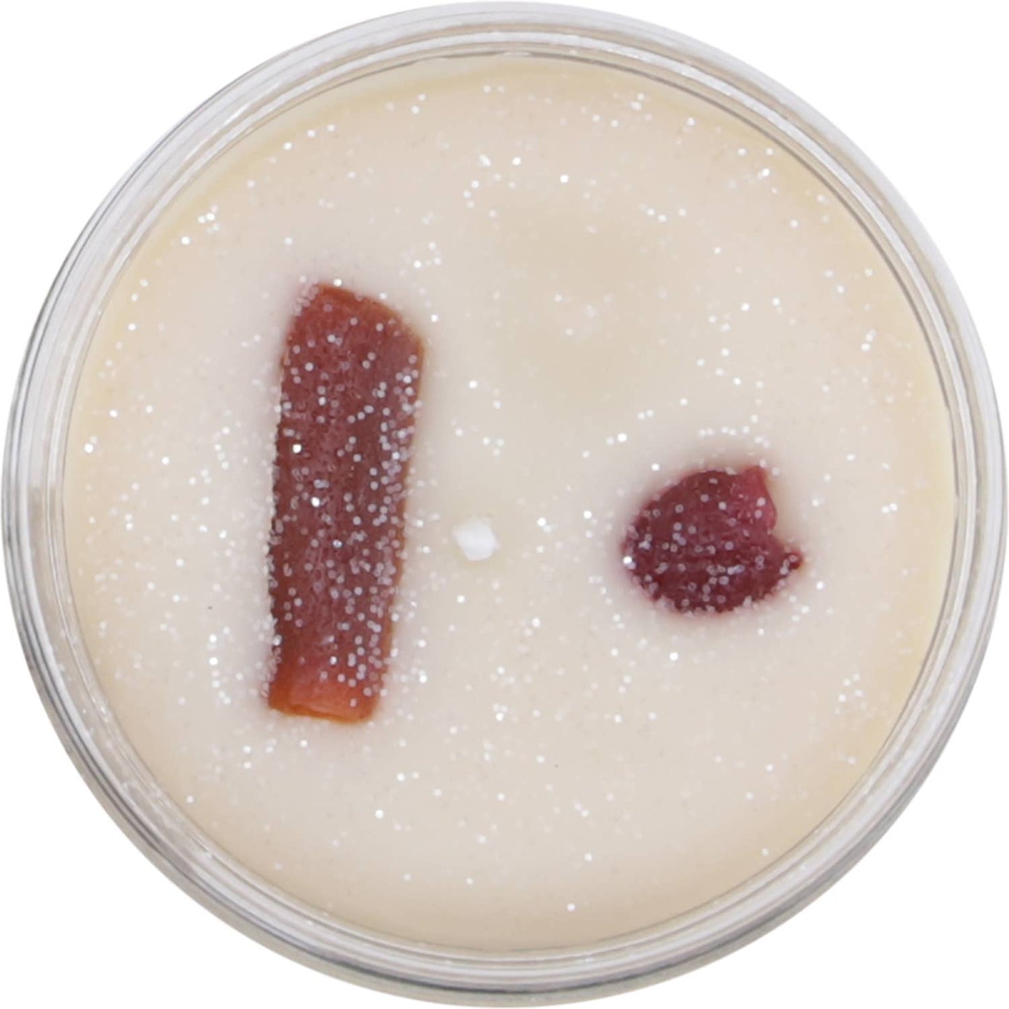 A creamy white candle with glitter and red accents, perfect for a country home scent.