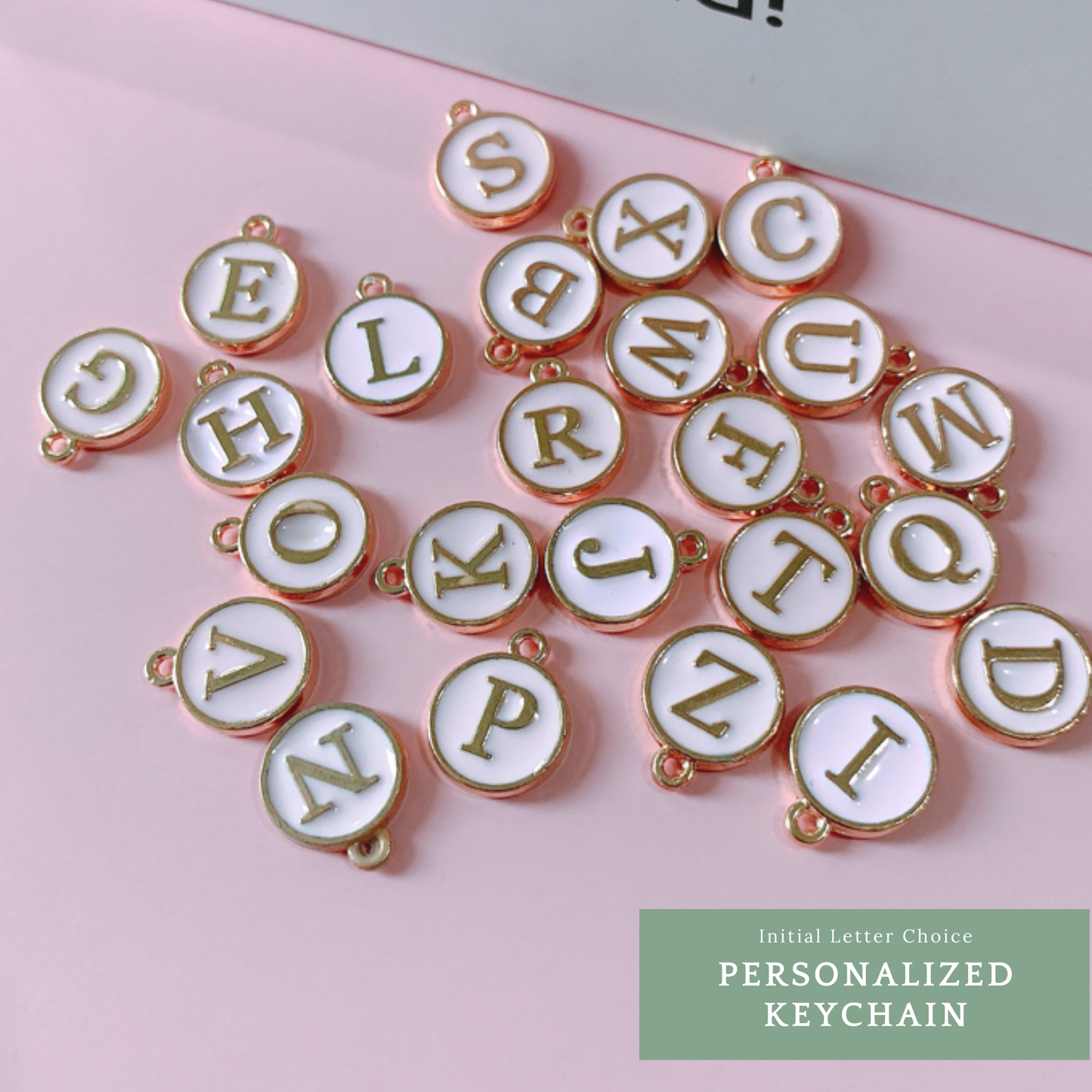 Personalized keychain with white and gold initial charms, perfect for custom gifts.