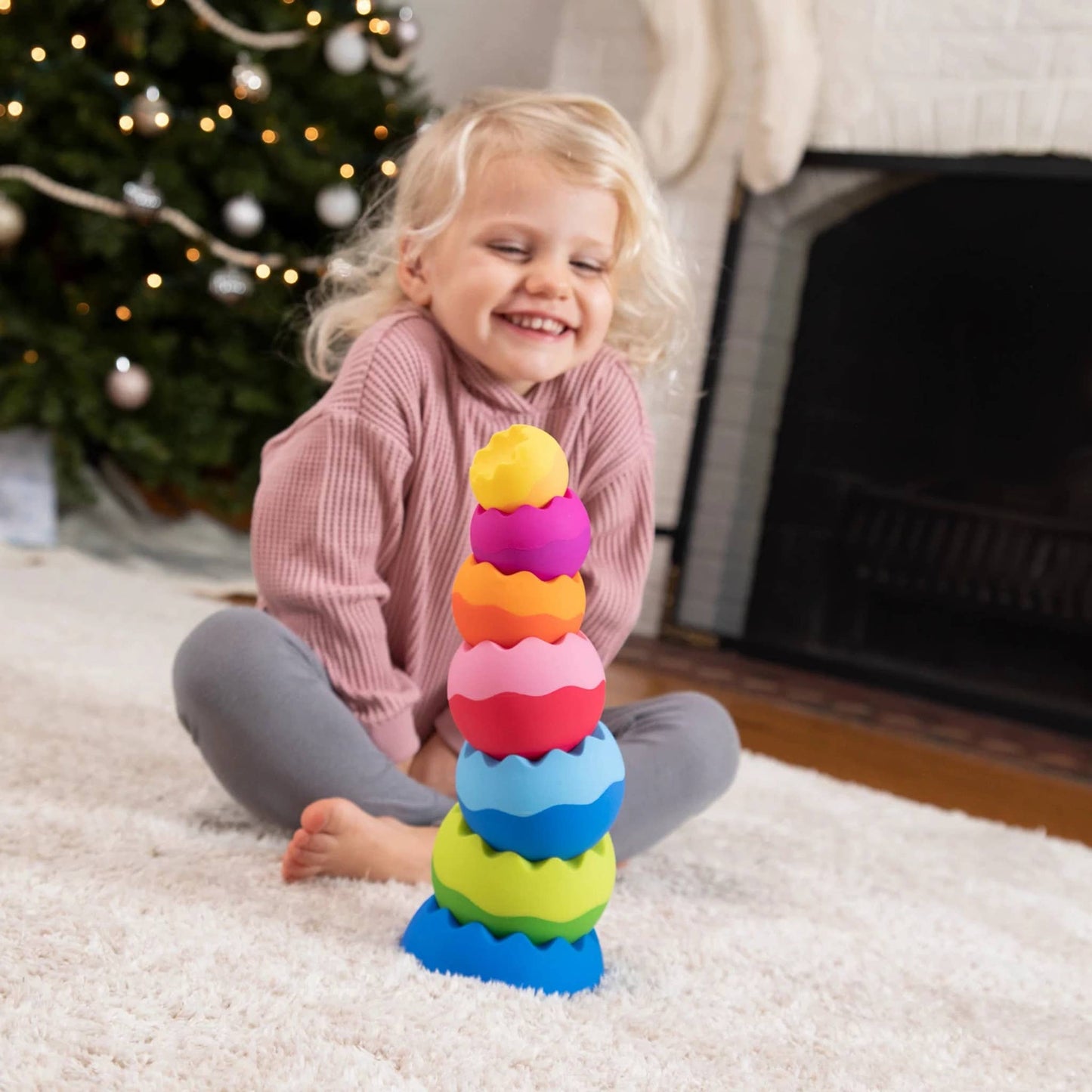 Colorful stacking toy with tactile texture, featuring vibrant rainbow rings for sensory play.