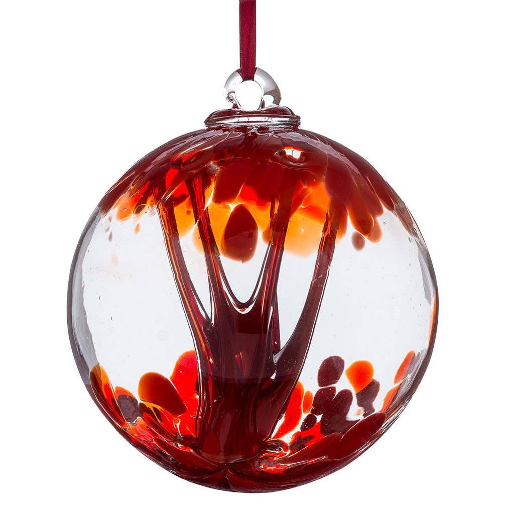 Red glass spirit ball with flowing color patterns and hanging ribbon