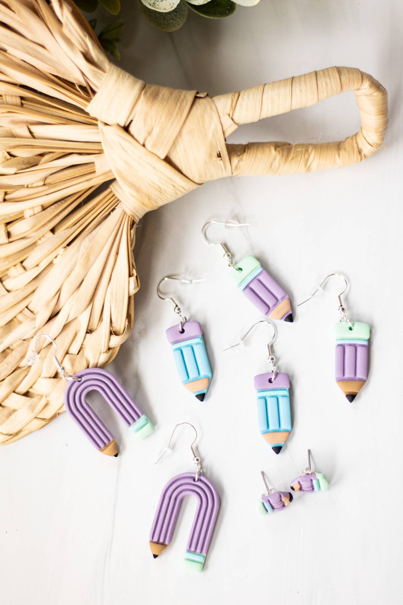 Blue pastel pencil dangle earrings with purple accents, perfect for a whimsical touch.