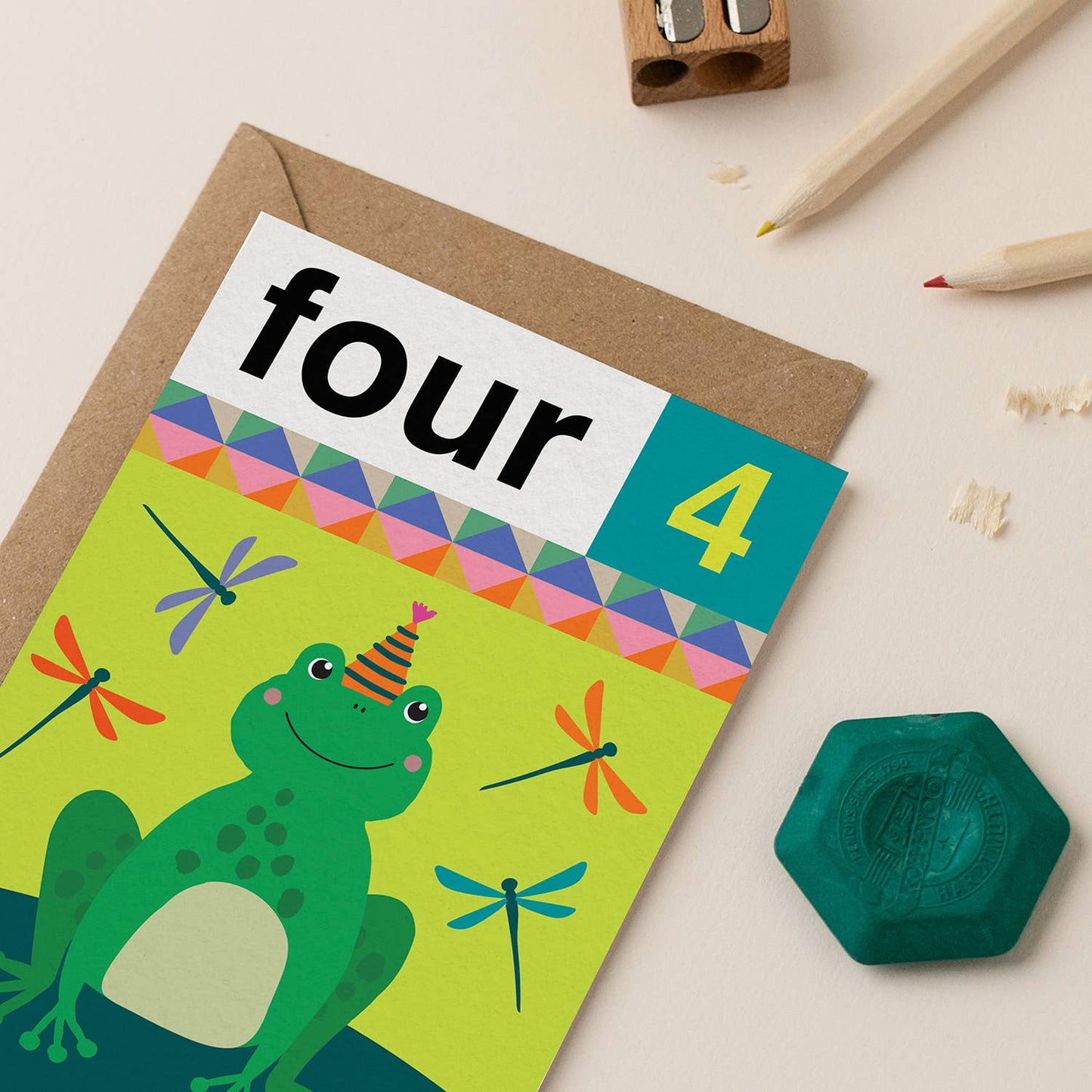Gender-neutral 4th birthday card featuring a cheerful green frog with a party hat and colorful dragonflies.