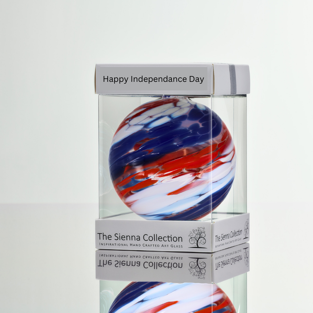A 10cm glass friendship ball with red, white, and blue swirls, perfect for Independence Day decor.