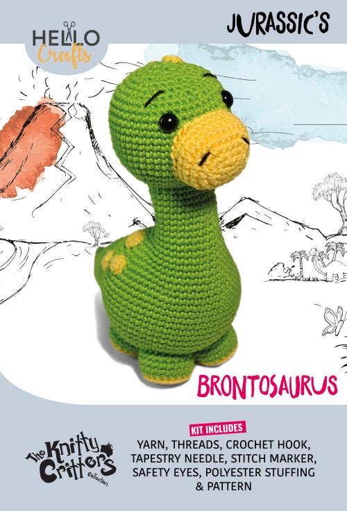 Crochet Brontosaurus in green and yellow with safety eyes on kit packaging