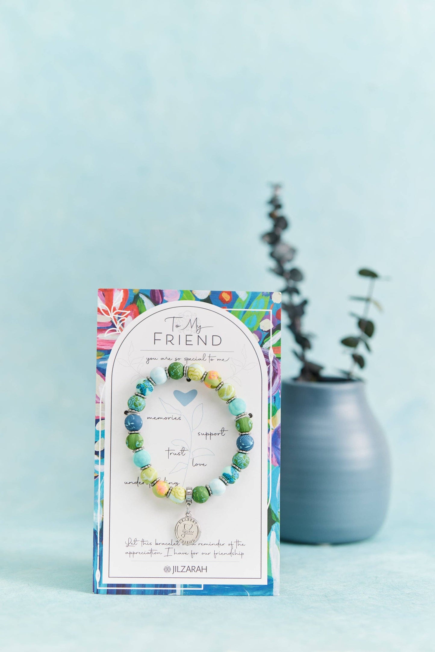 "A charming bracelet with multicolored beads and a small pendant, displayed on a decorative card as a thoughtful gift."