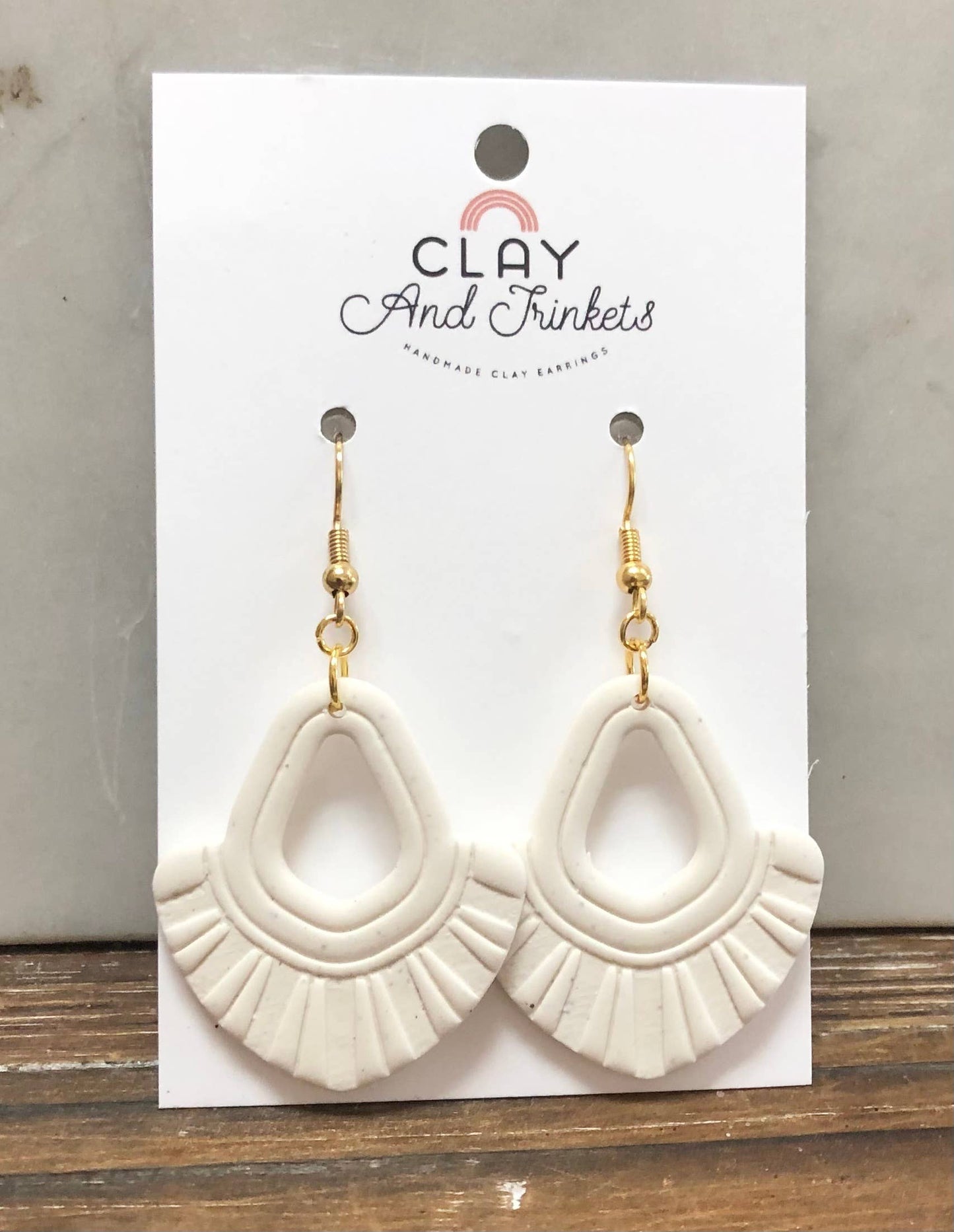 White clay dangle earrings with tassel texture and gold hooks