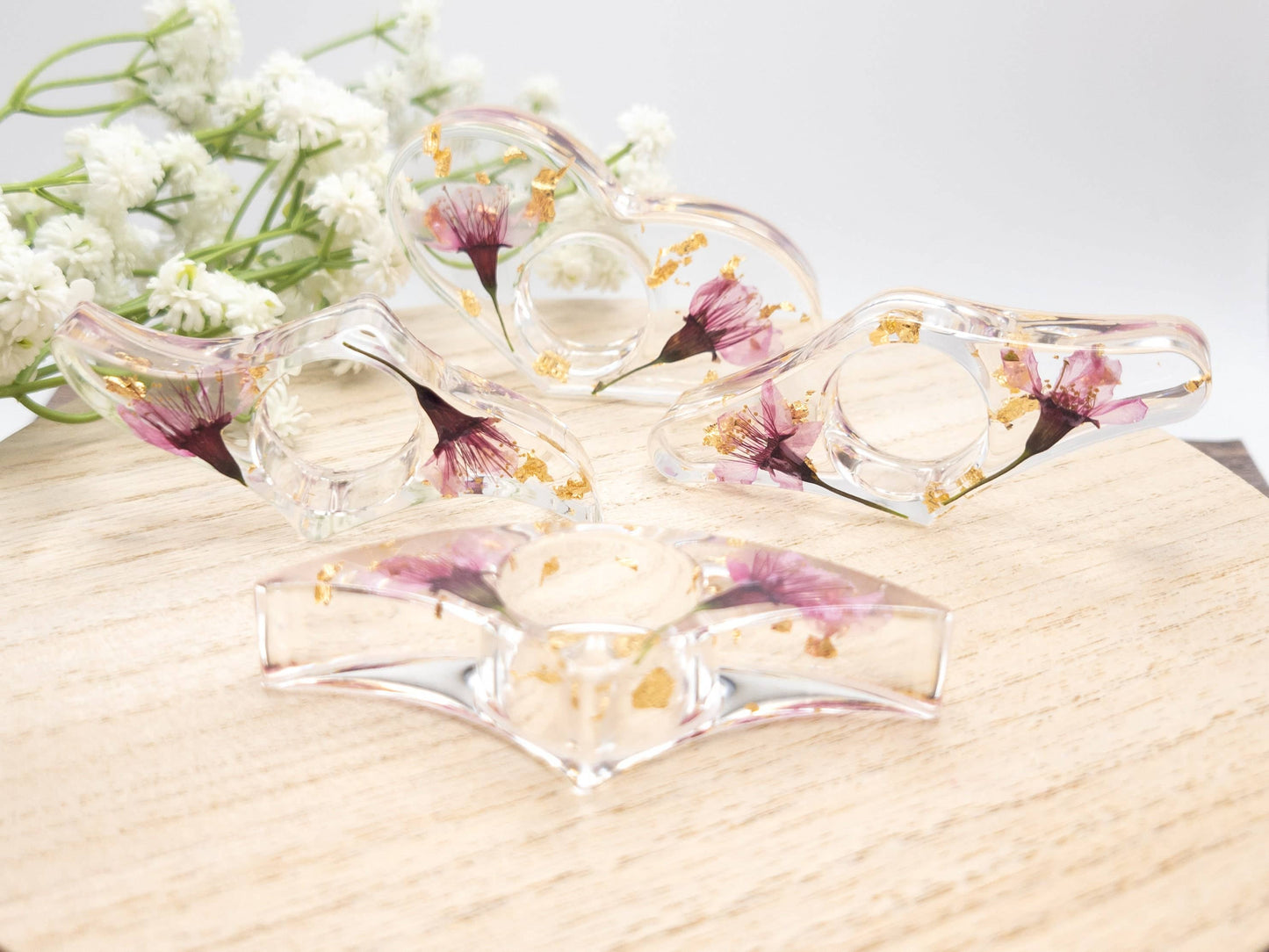 Clear resin book page holders with pressed flowers and gold flakes, set of 4 unique shapes.