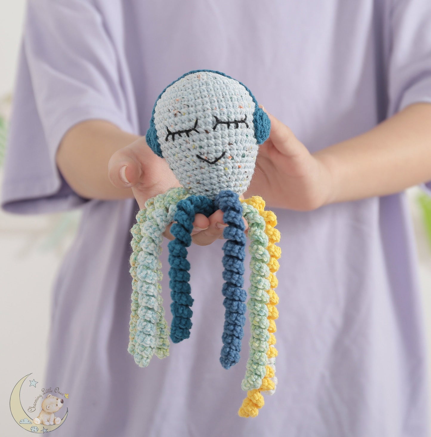 A handmade crochet ninja octopus toy with pastel colors and eight tentacles.
