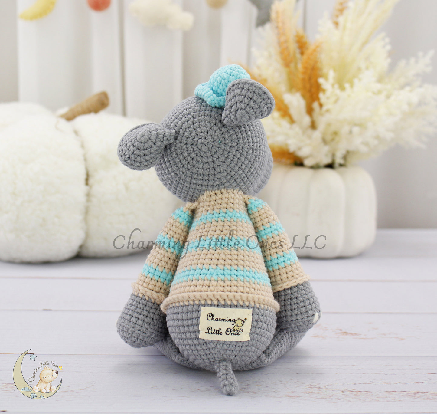 Handmade crochet hippo toy, 11 inches tall, with gray body, blue and cream striped boots, and a light blue top hat.