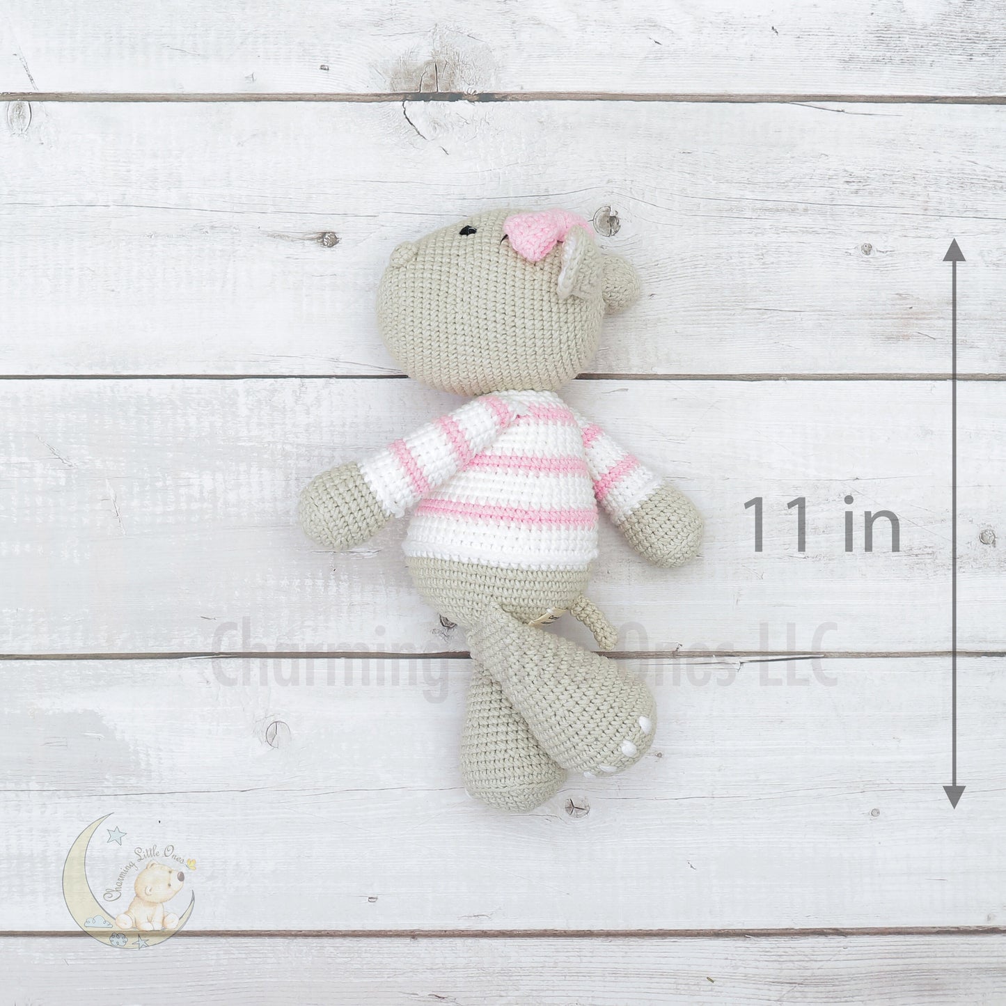 A handmade crochet hippo wearing a pink-striped sweater, 11 inches tall.