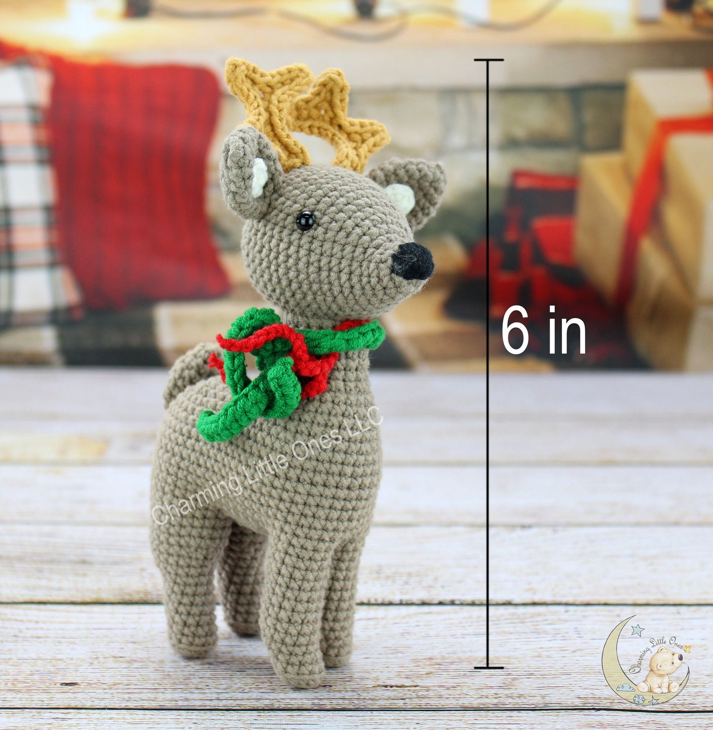 A handmade crochet Christmas stuffed reindeer with antlers, green and red scarf, standing 6 inches tall.