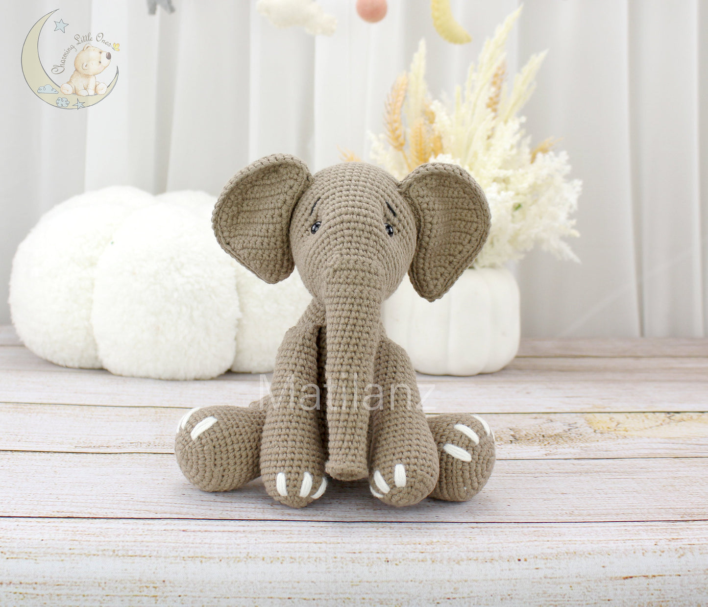 Handmade crochet elephant, 8 inches tall, with soft gray yarn and white-tipped feet, perfect for cuddling.