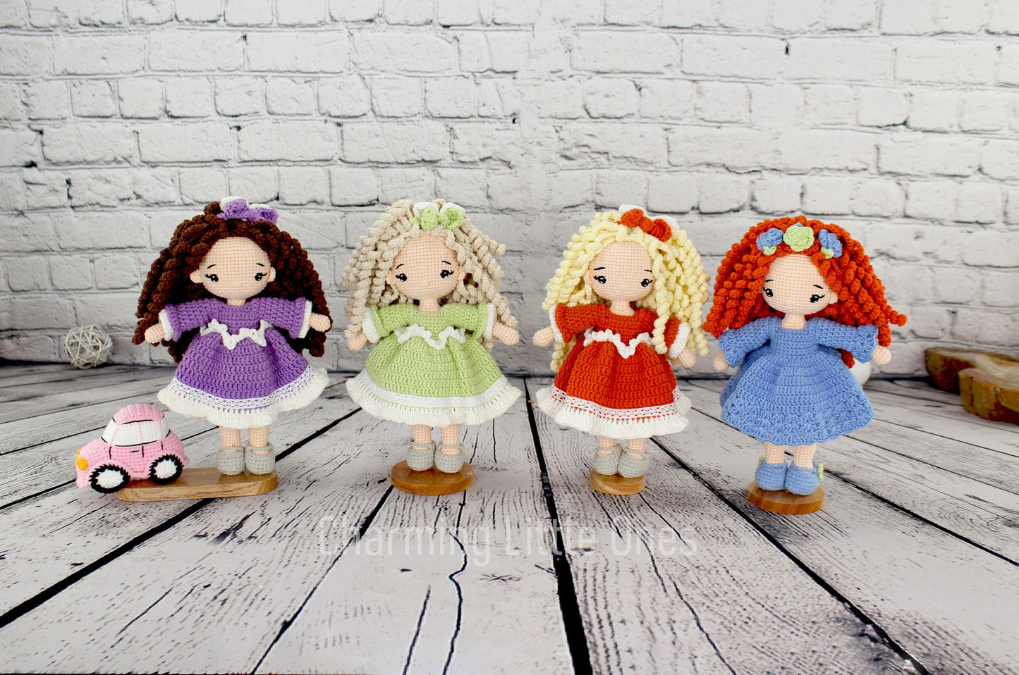 Handmade crochet doll with colorful dress, curly hair, and flower accessory, standing 10 inches tall.