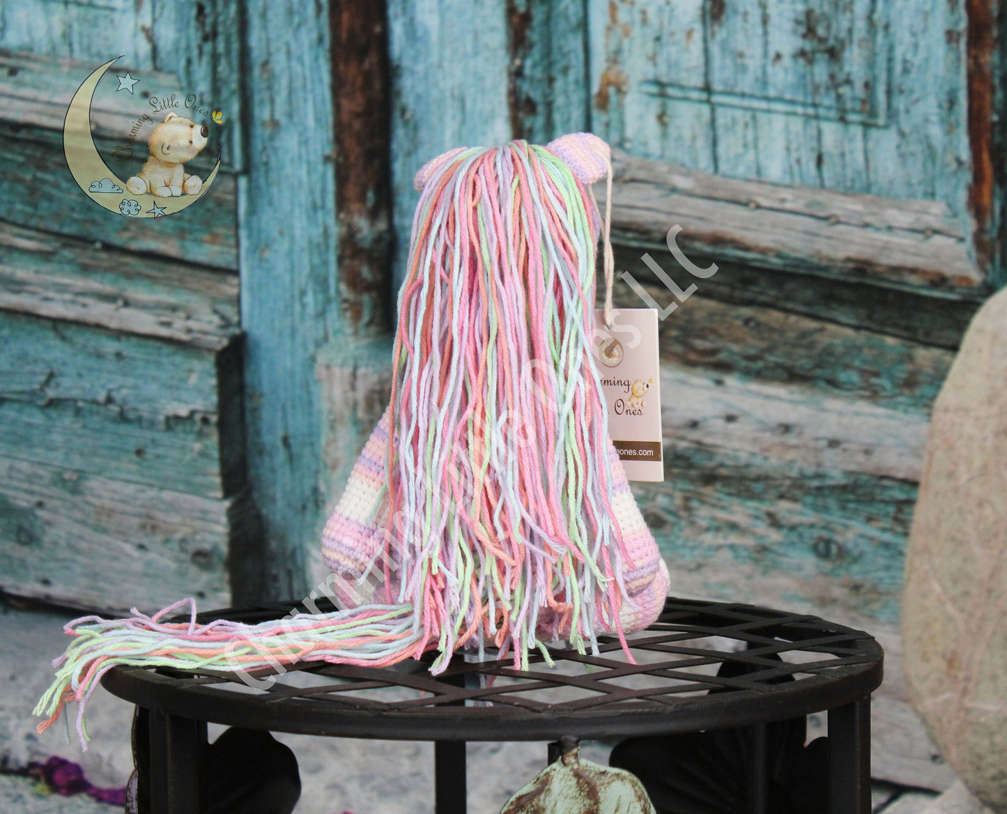 A charming pink crochet horse with a colorful, fringed mane and tail, perfect for playtime.