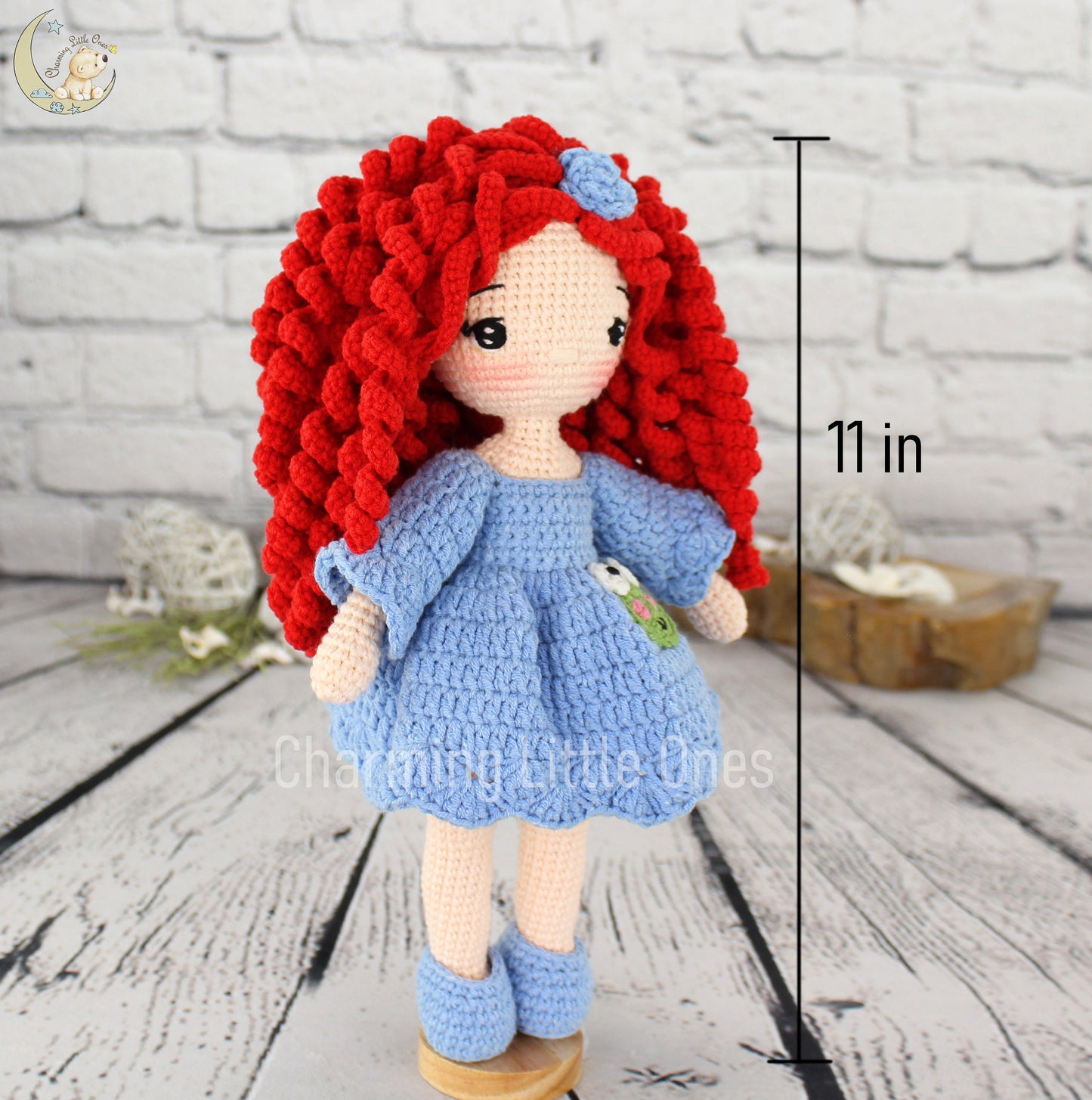 Handmade crochet doll with vibrant red hair, blue dress, and matching shoes, standing 11 inches tall.