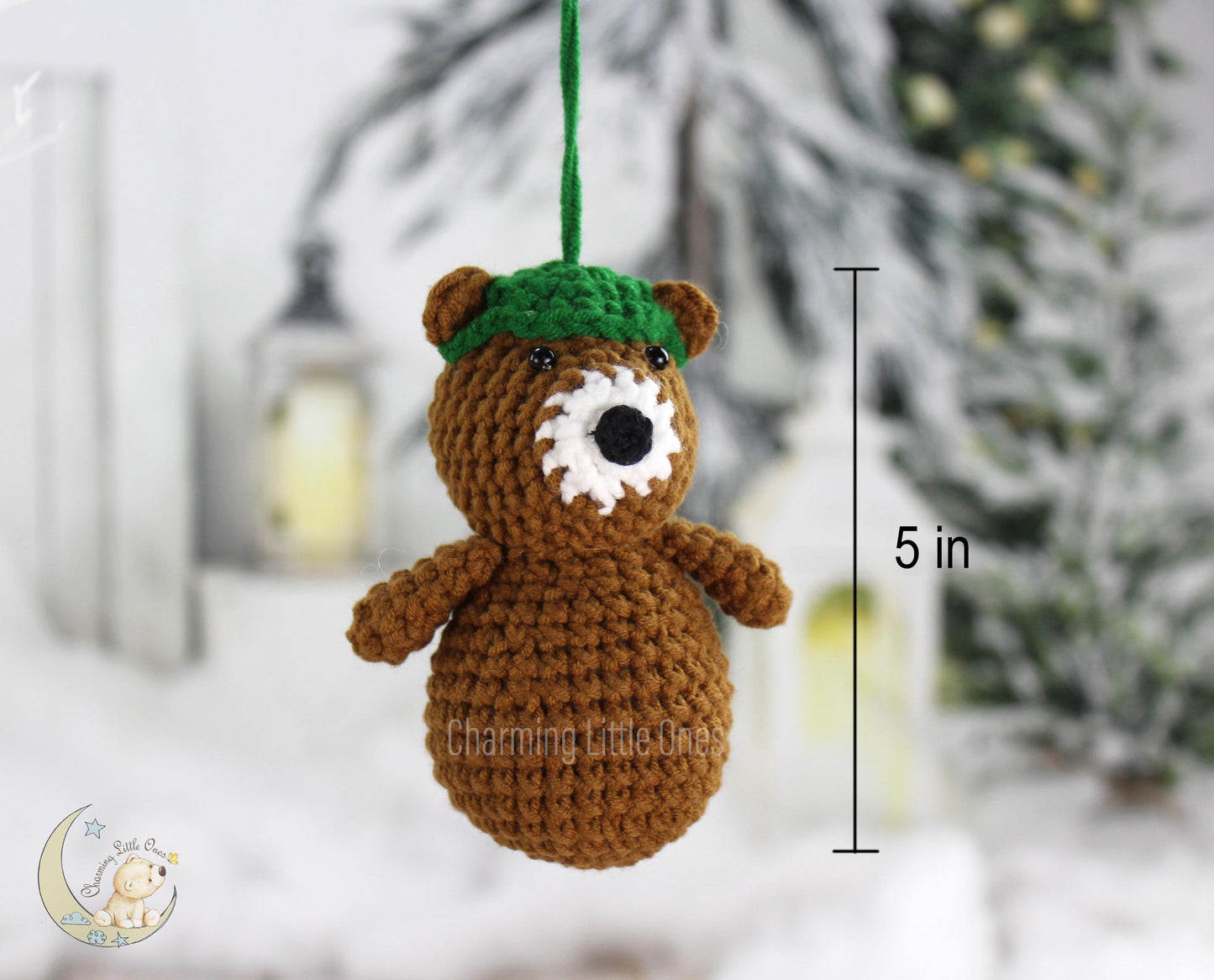 Handmade crochet bear ornament with a green hat and white snout, perfect for Christmas decorating.