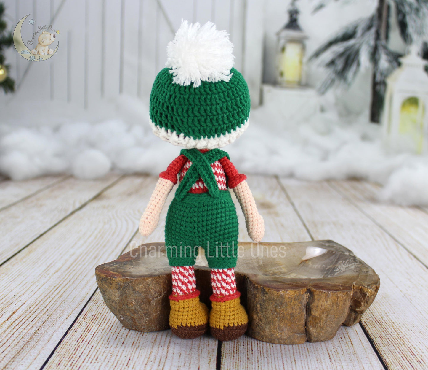 Handmade crochet Christmas doll in green and red, wearing a festive hat with a white pom-pom.