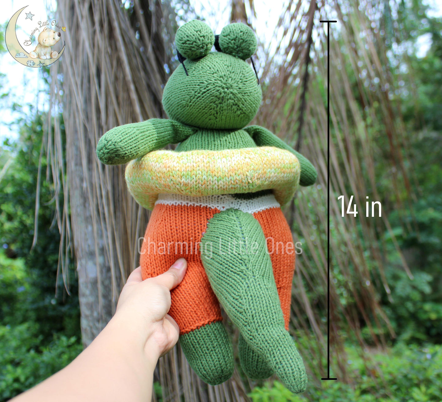 A handmade knitted alligator toy in green and orange, 14 inches tall.