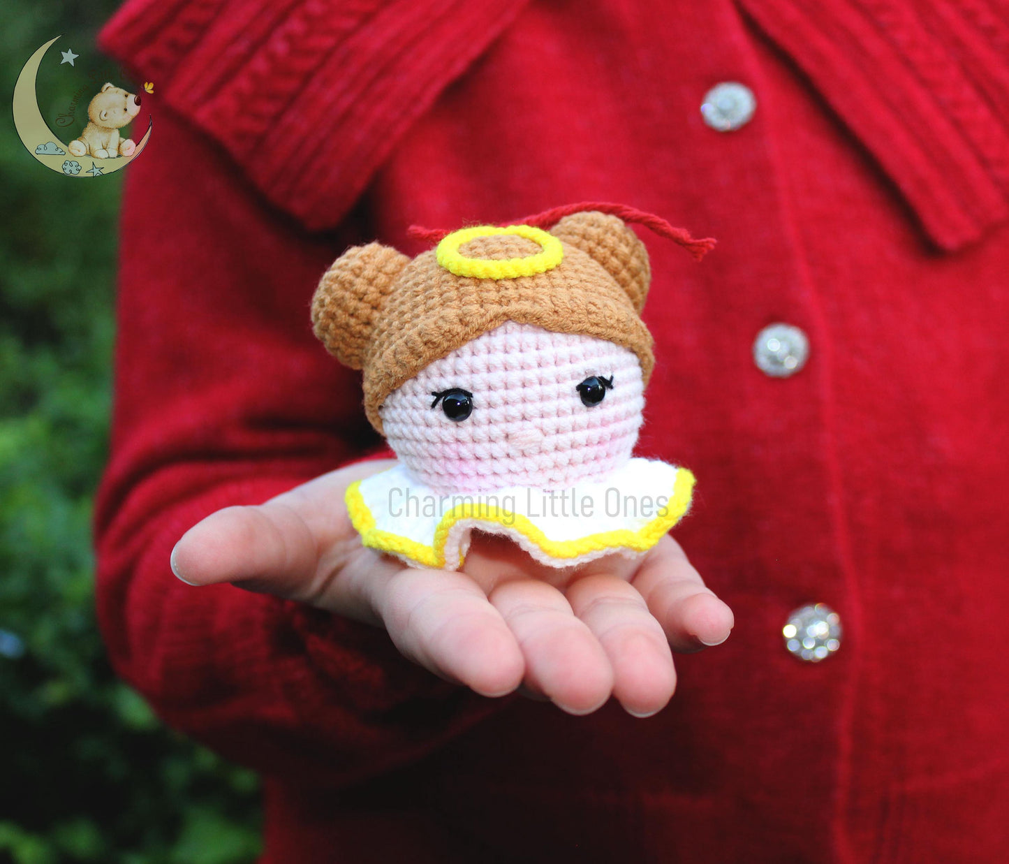 Cute crochet little angel ornament with a yellow halo, brown hair, and a white dress with yellow trim.