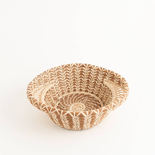 Shallow pine needle basket with intricate raffia stitching and lacy side handles.