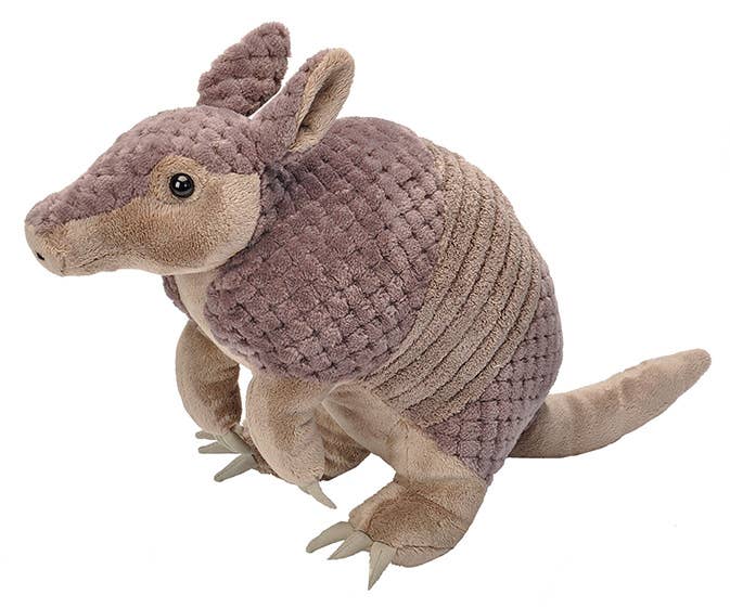 Realistic armadillo plush toy with textured brown shell, pointed snout, and long tail; upright sitting pose.