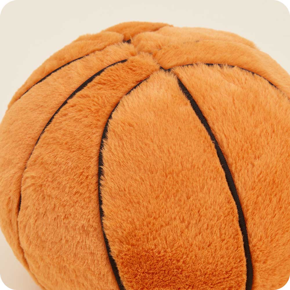 Cozy orange plush basketball with black stitching, microwavable and scented for comfort.