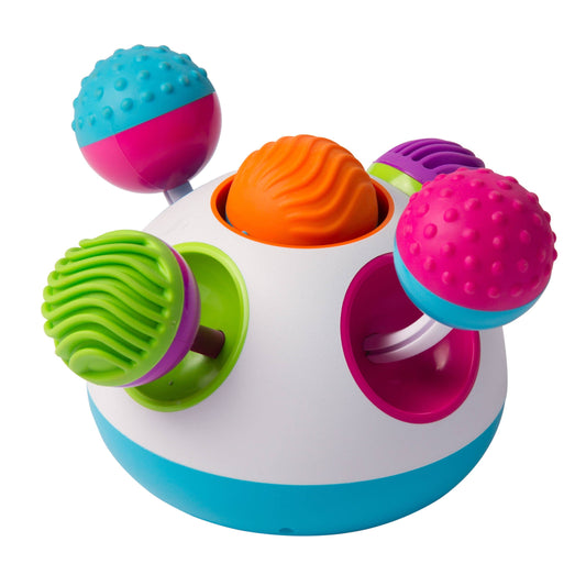 Baby interacting with a multi-sensory toy featuring colorful textured balls and spinning elements.