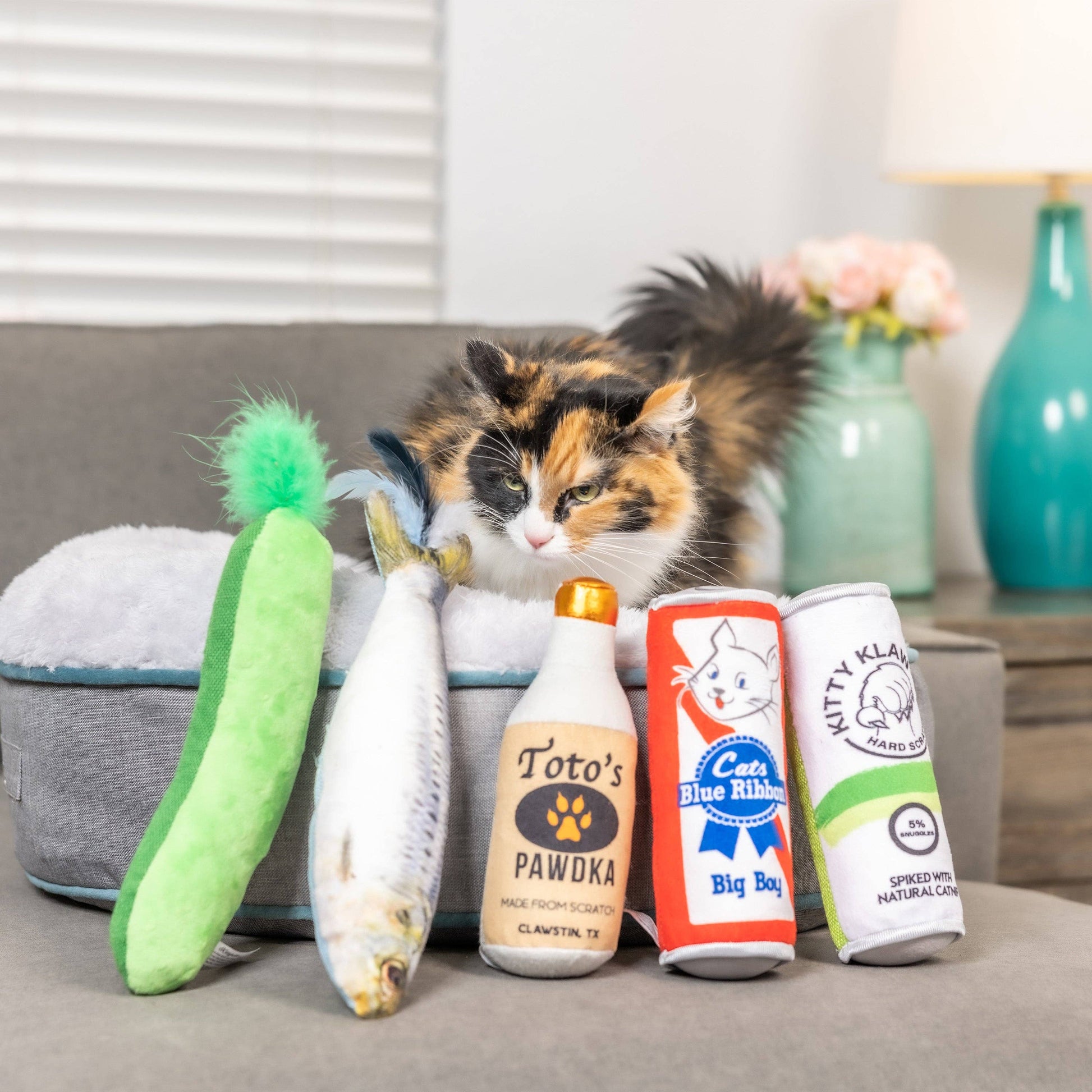 Plush sardine-shaped cat toy with feathered tail, filled with catnip.