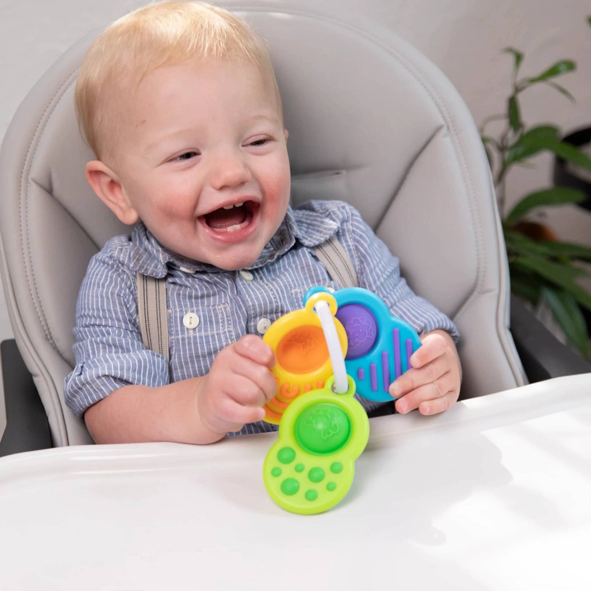 A colorful sensory ring toy set featuring three interlocking rings with textured surfaces and bright colors.