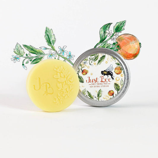 Yellow lotion bar with embossed floral design and mint-orange themed tin