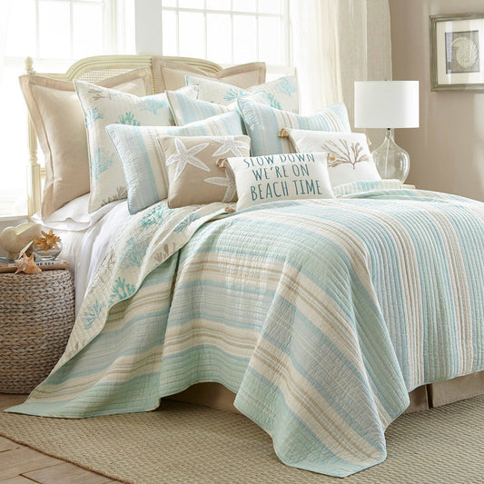Coastal-inspired reversible quilt set in cream, taupe, and light blue tones