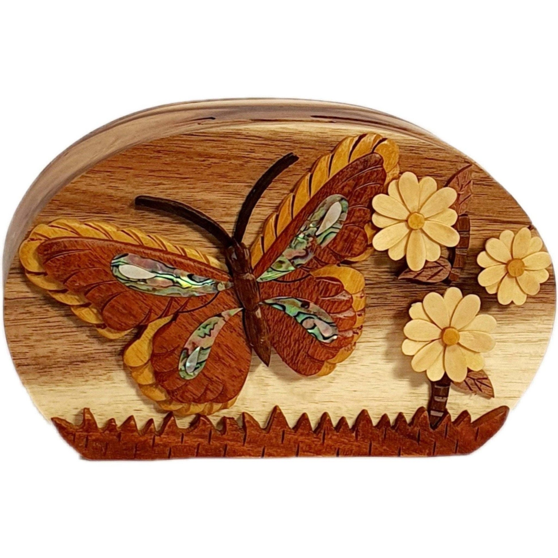 Hand-carved wooden keepsake box featuring a butterfly and daisies with mother of pearl inlay.