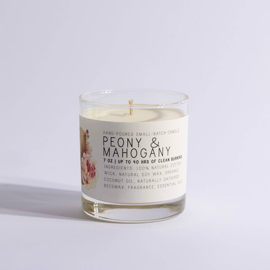 Glass jar candle labeled Peony & Mahogany with floral design