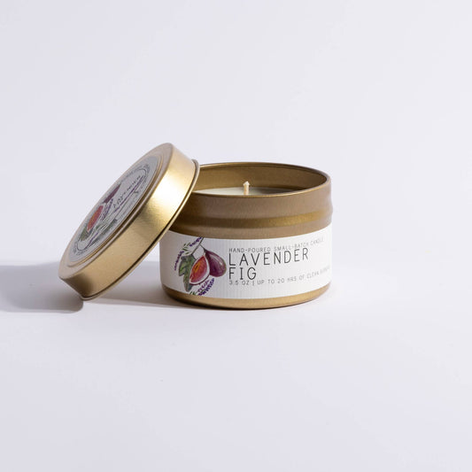 Gold tin candle labeled Lavender Fig with illustrated fig and lavender sprigs